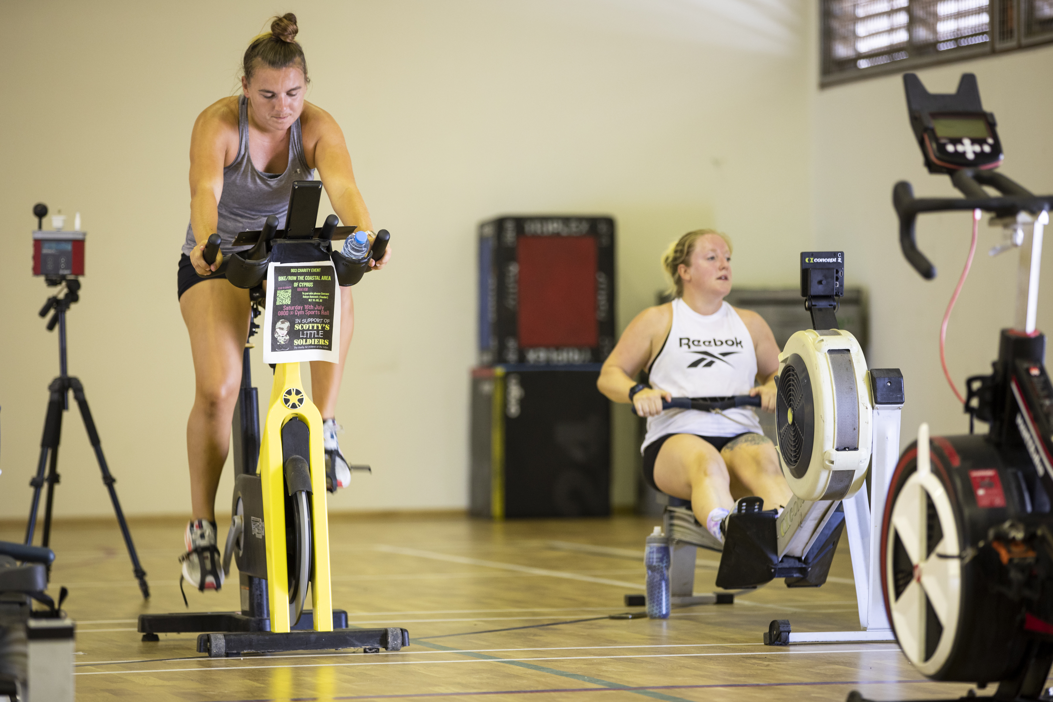 Image shows aviators in the gym on stationary bike and rowing machine.